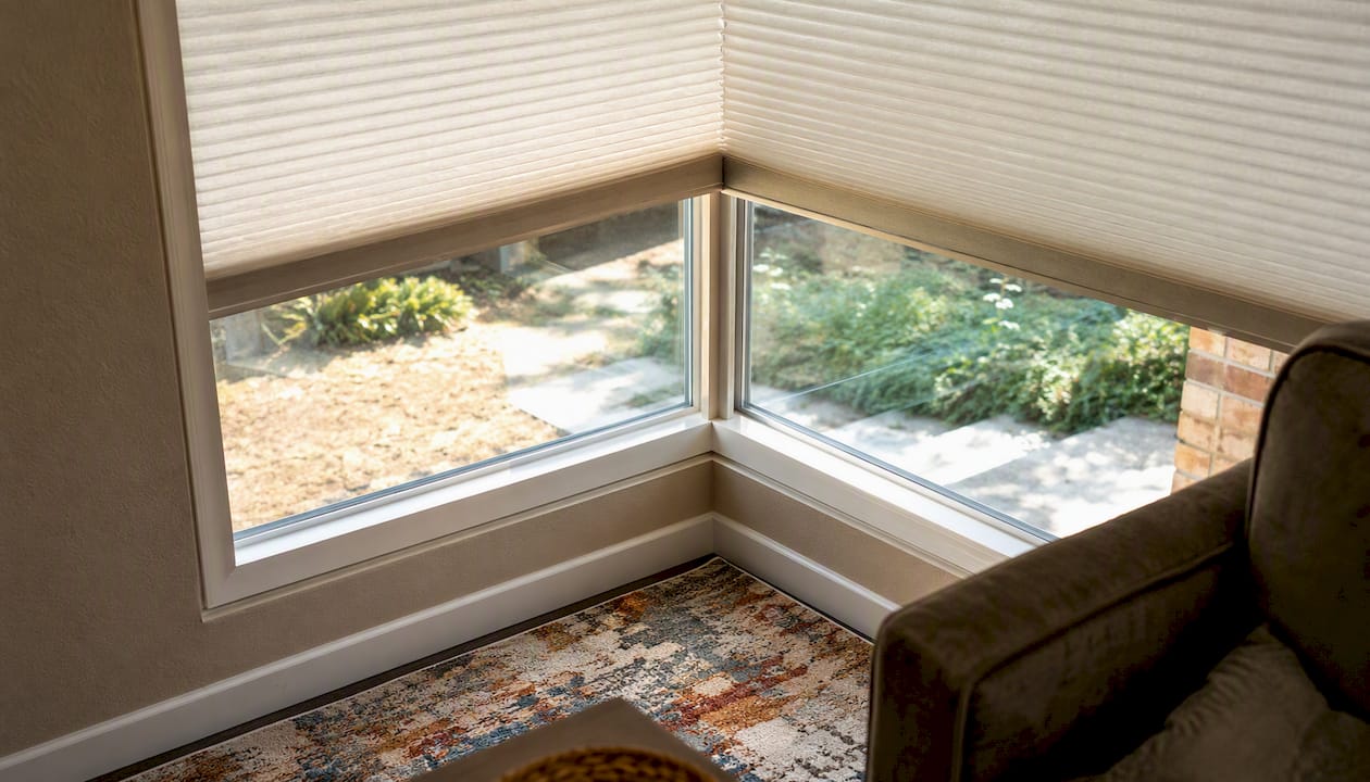 Corner window with cellular and roller shades installed