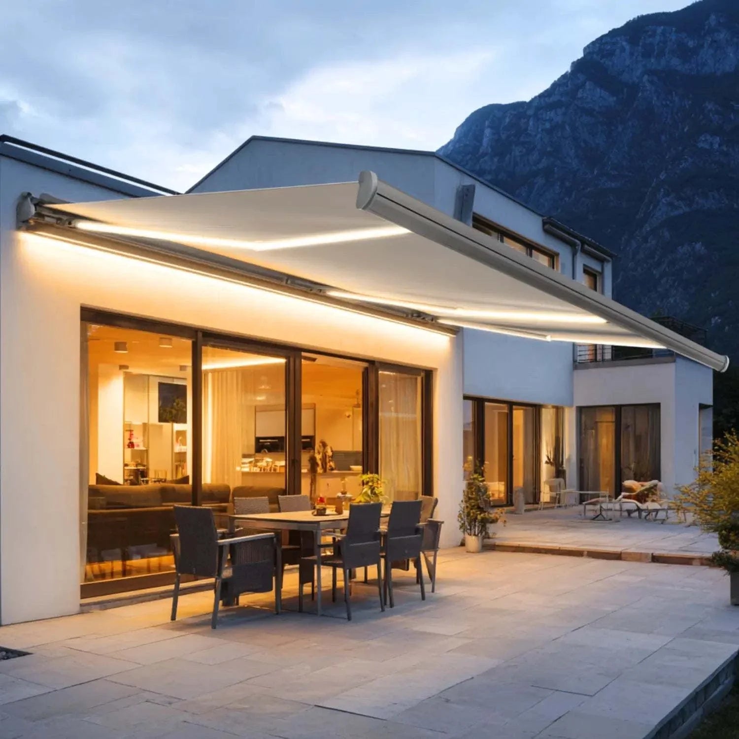 Value Blinds® Motorized Retractable Awnings full cassette on modern patio at dusk providing outdoor shade