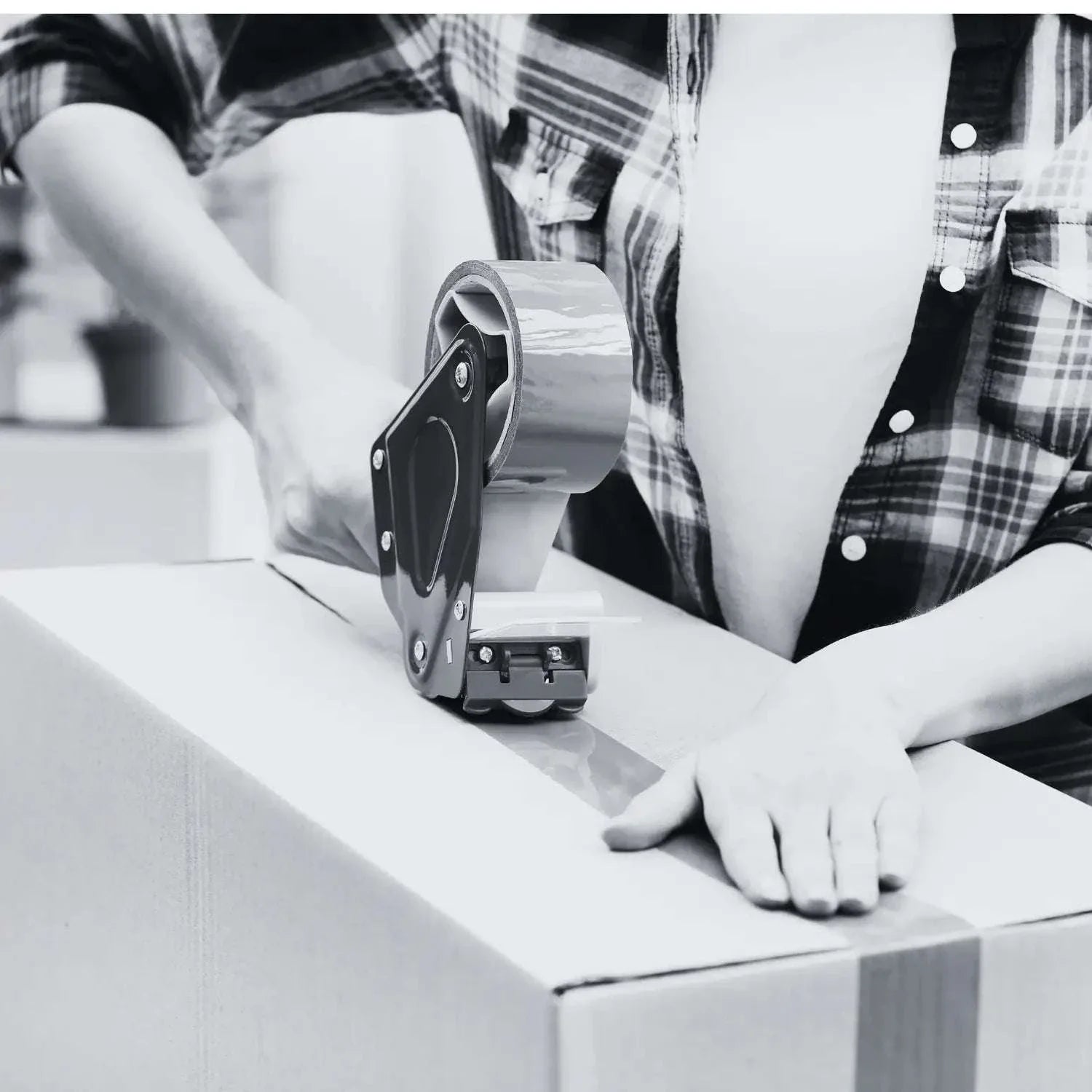 Person sealing a cardboard box with tape for sample processing fee handling and packaging