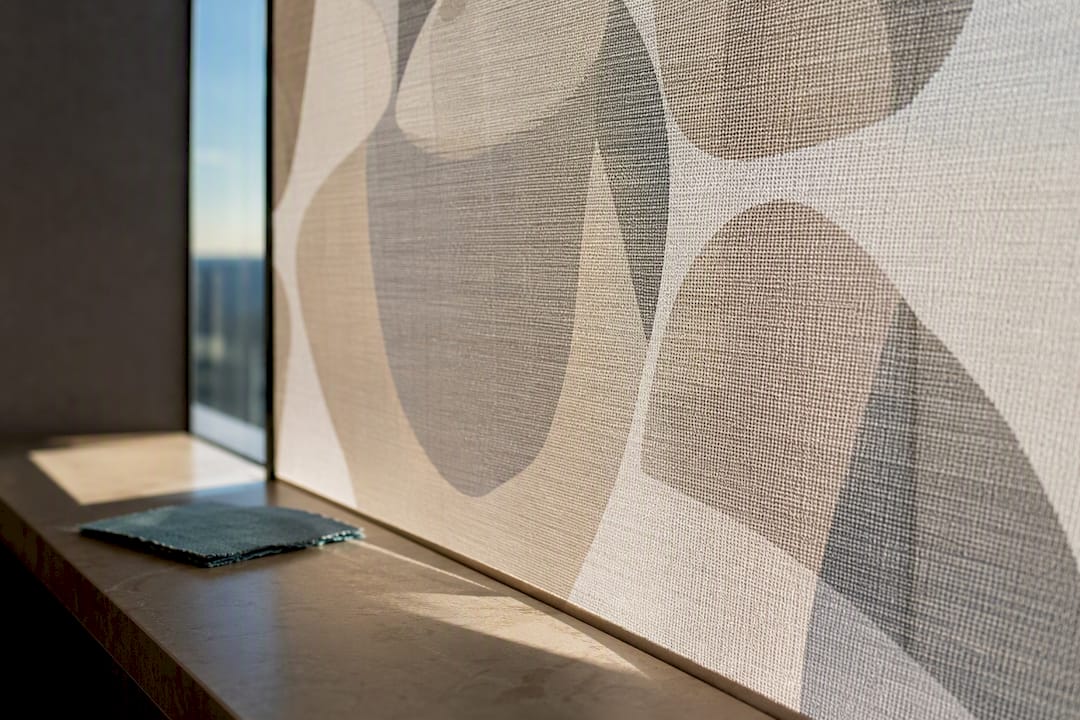 Printed shade fabric filtering storefront sunlight