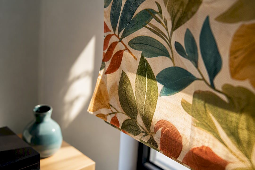 Botanical printed shade catching dramatic light