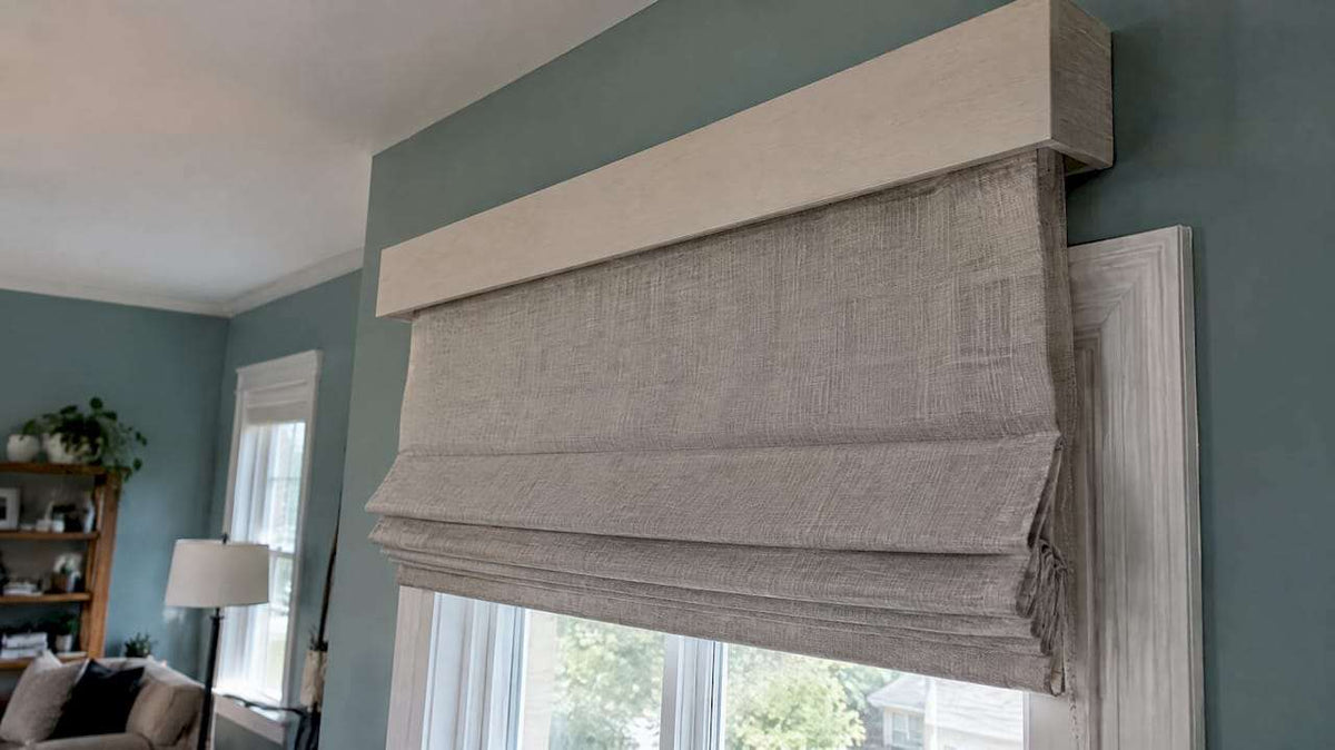 Roman shade mounted above window trim